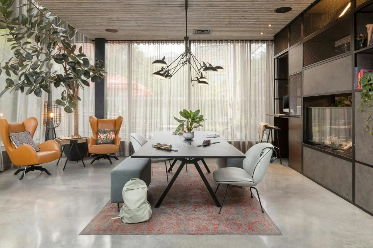 A dining room with a table and chairs at Moxy York, York city centre