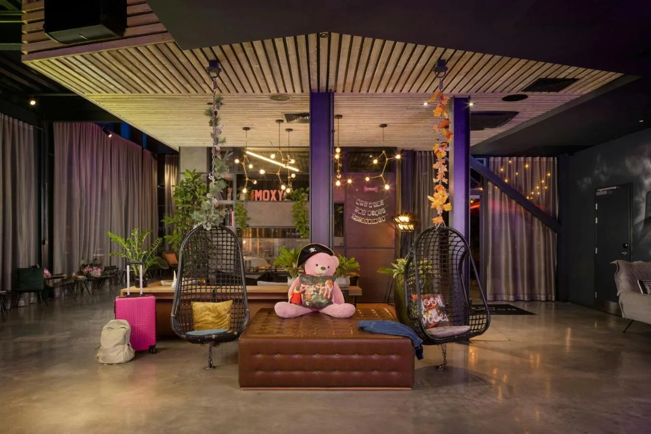 A doll sitting on a couch in a lounge area at Moxy York, York